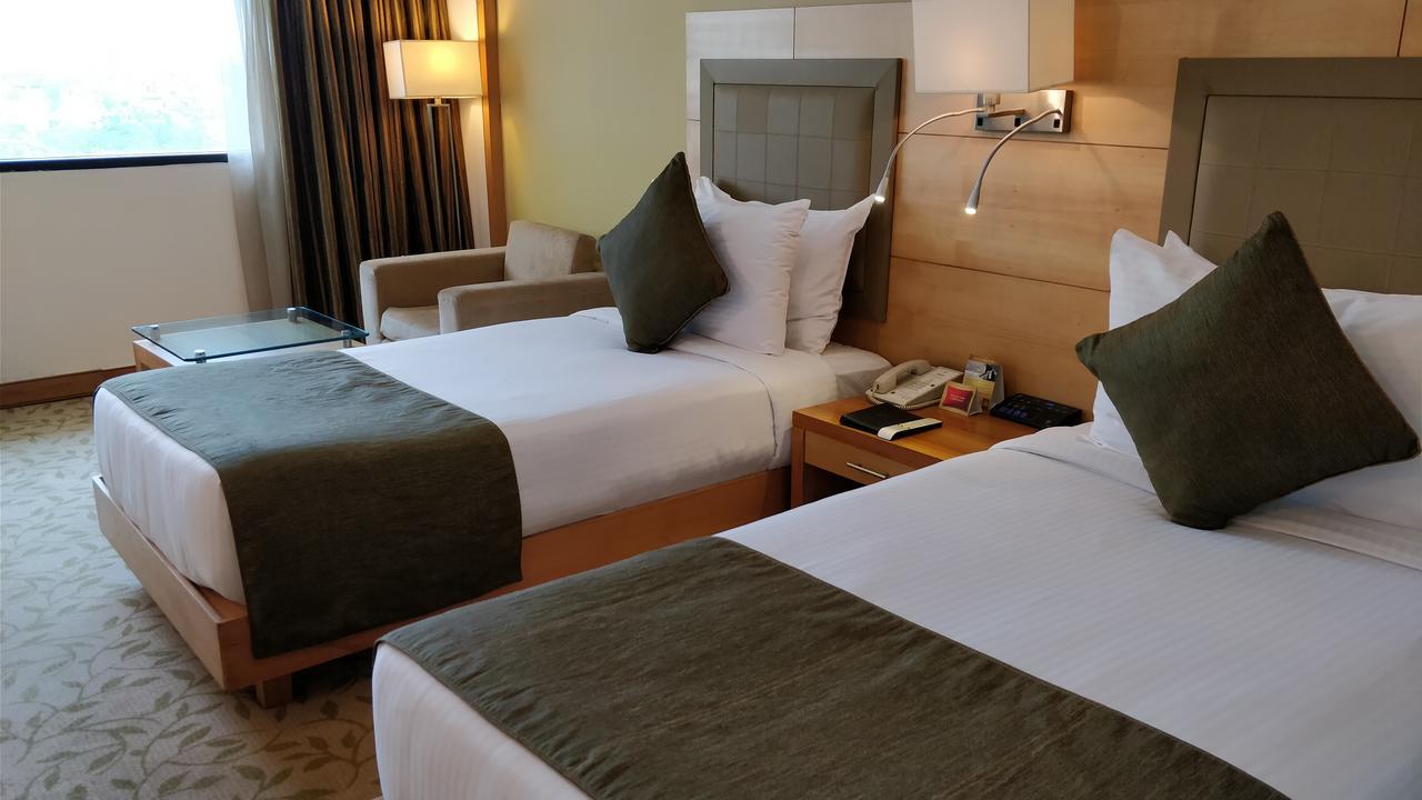 The Suryaa New Delhi Hotel Kültér fotó A room at the hotel