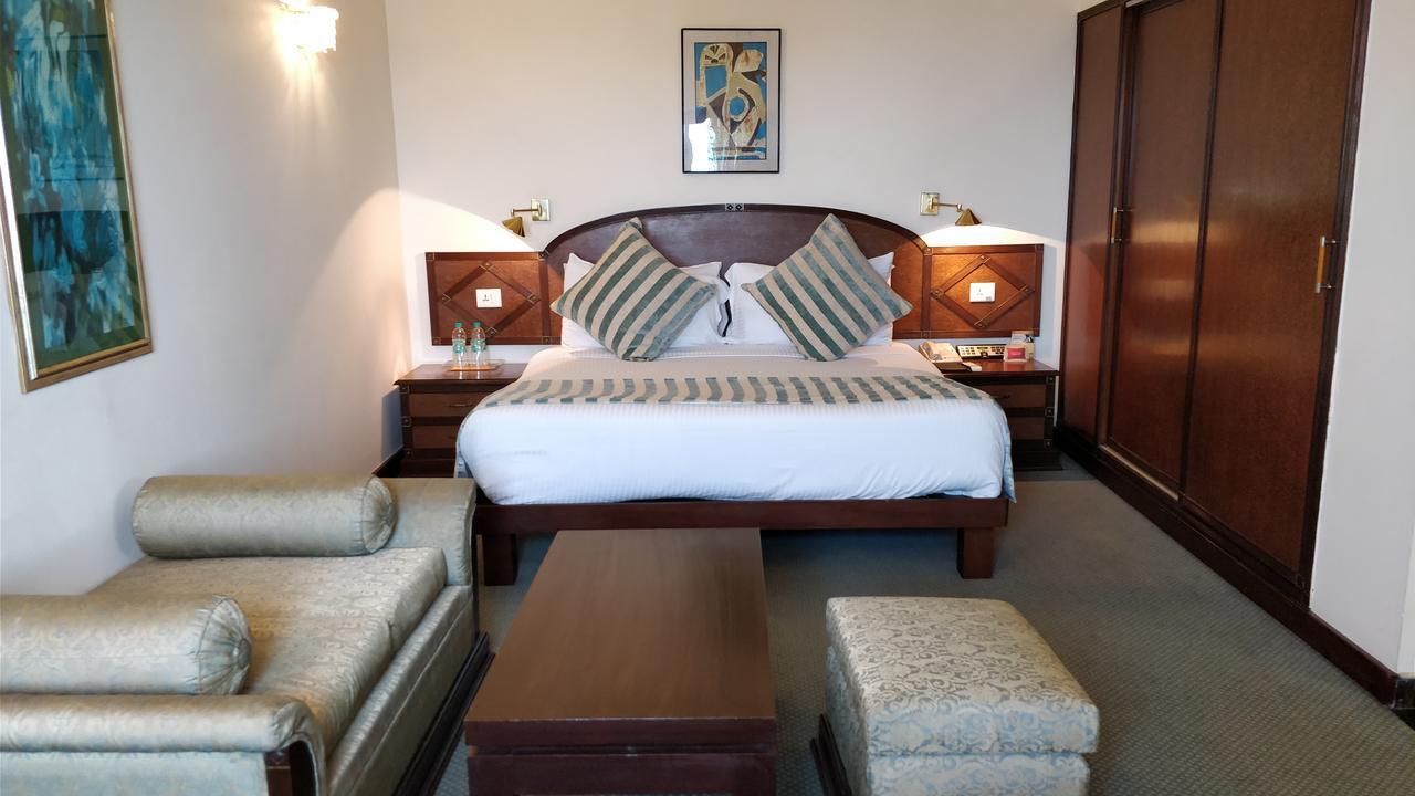 The Suryaa New Delhi Hotel Kültér fotó A room at the hotel