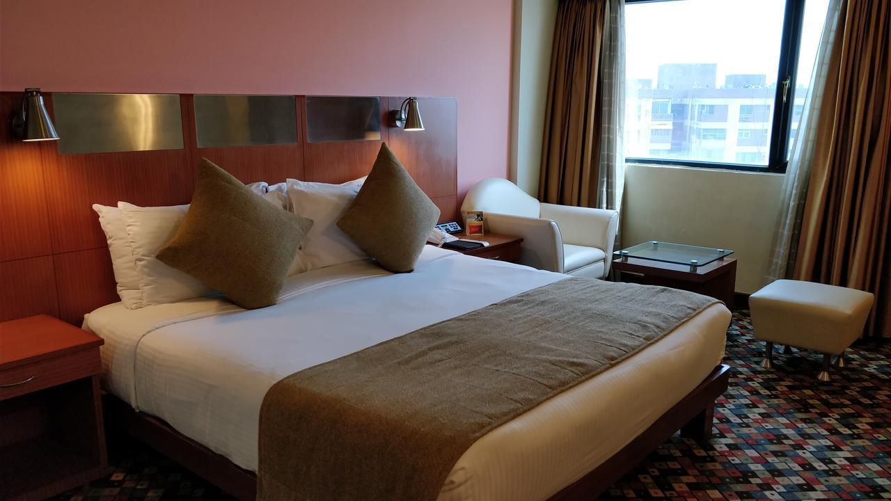The Suryaa New Delhi Hotel Kültér fotó A room at the hotel