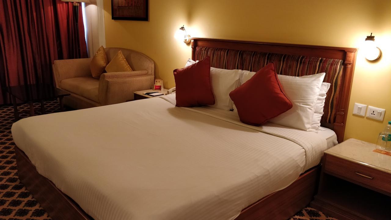 The Suryaa New Delhi Hotel Kültér fotó A room at the hotel
