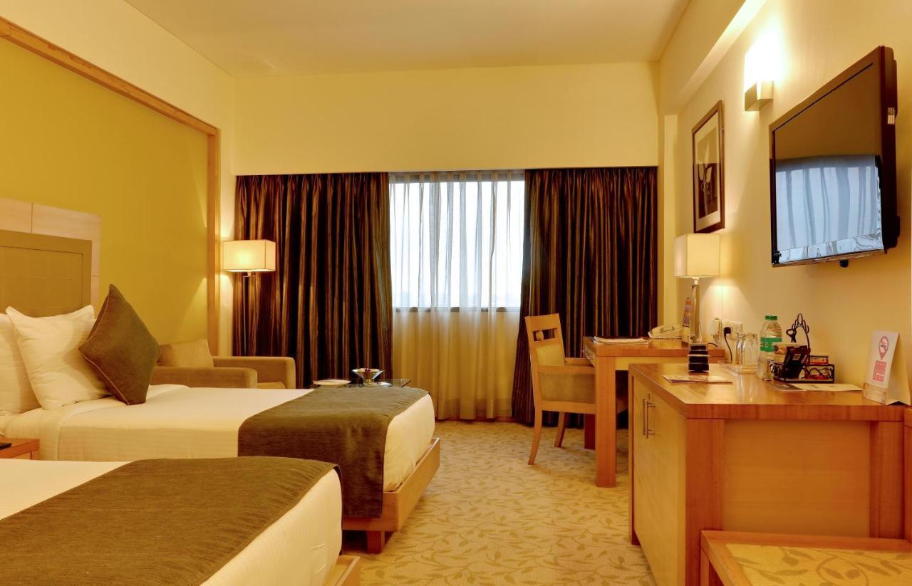 The Suryaa New Delhi Hotel Kültér fotó A room at the hotel
