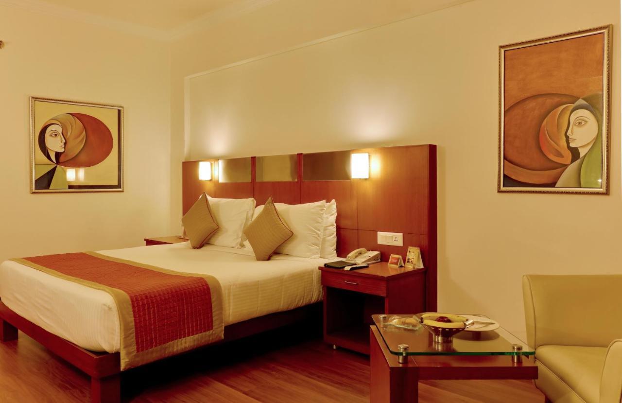 The Suryaa New Delhi Hotel Kültér fotó A room at the hotel