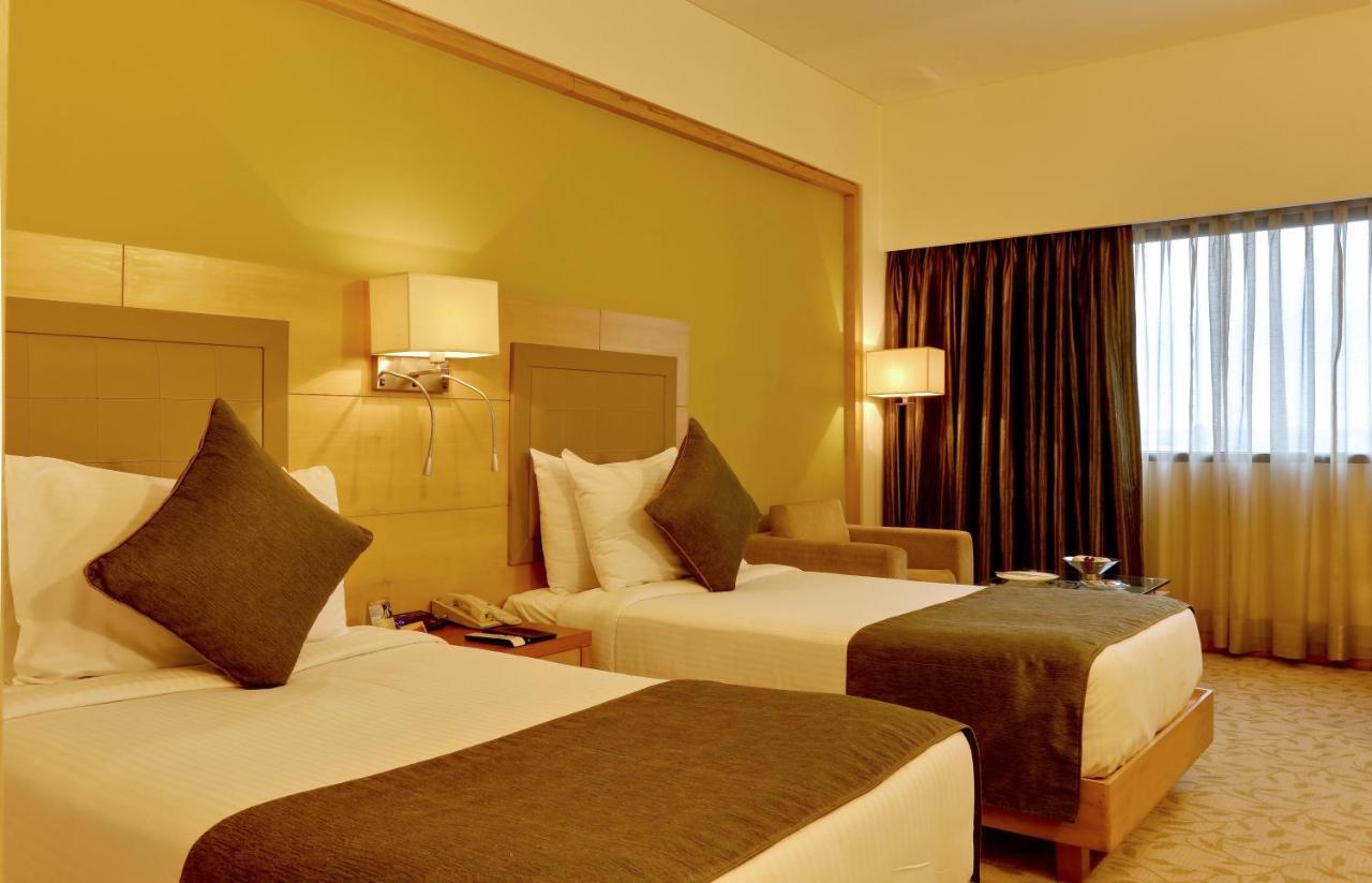 The Suryaa New Delhi Hotel Kültér fotó A room at the hotel