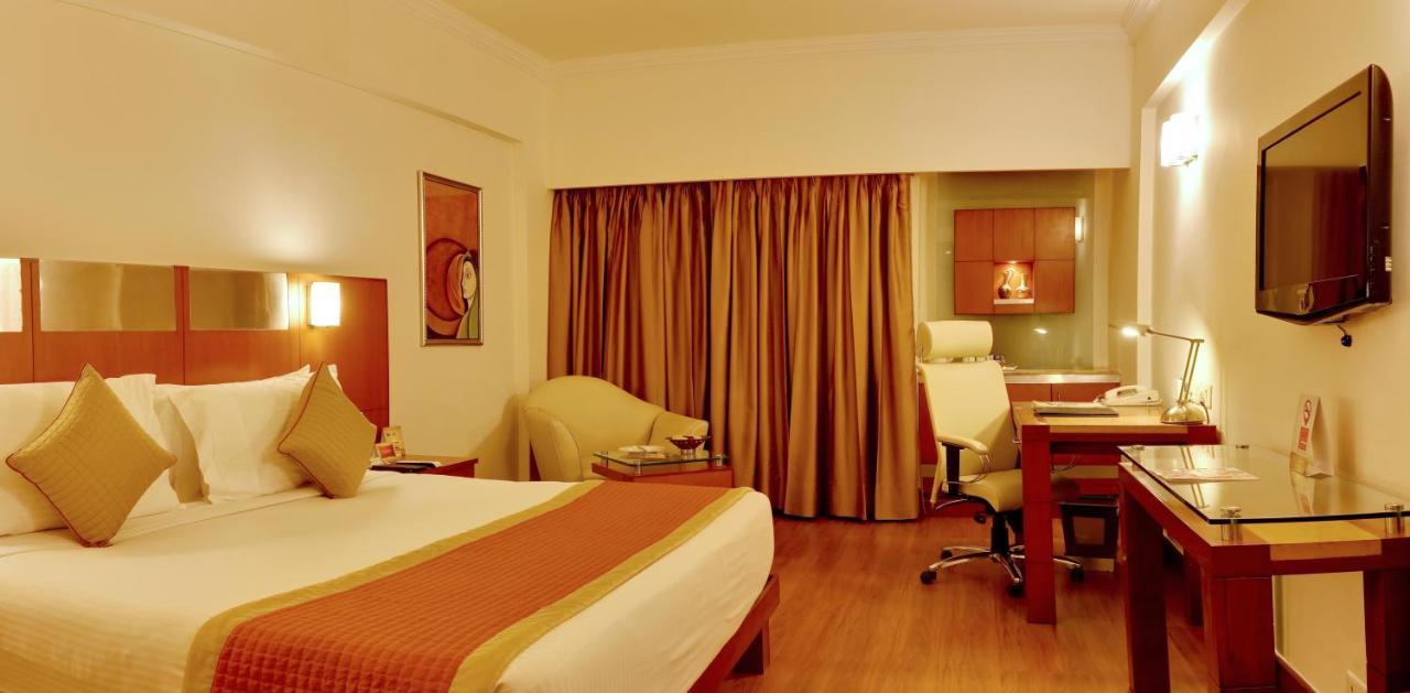 The Suryaa New Delhi Hotel Kültér fotó A room at the hotel