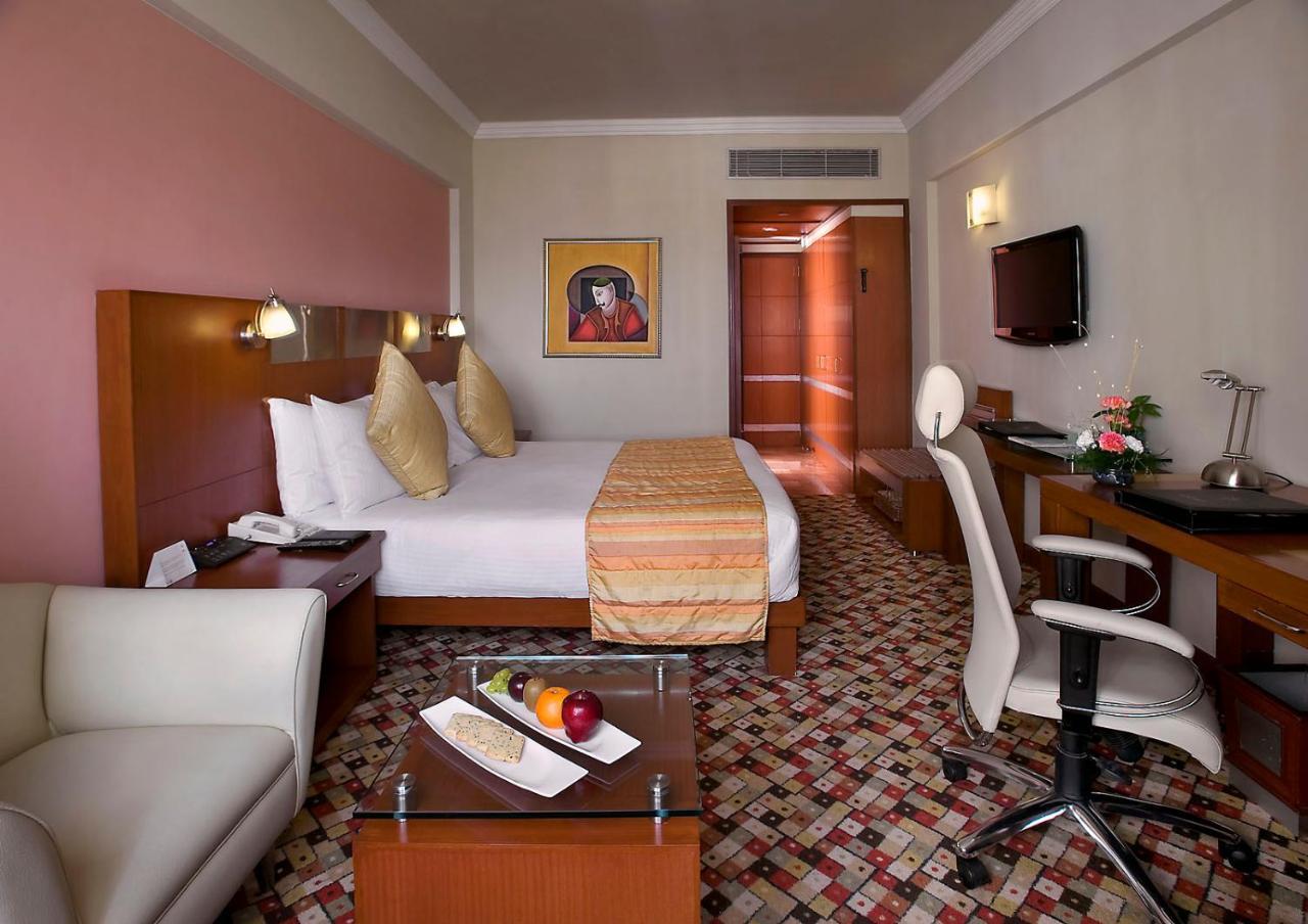 The Suryaa New Delhi Hotel Kültér fotó A room at the hotel
