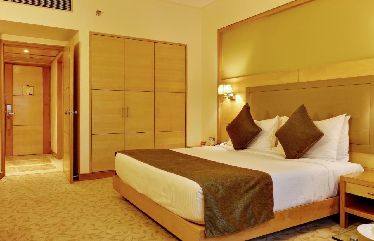 The Suryaa New Delhi Hotel Kültér fotó A room at the hotel