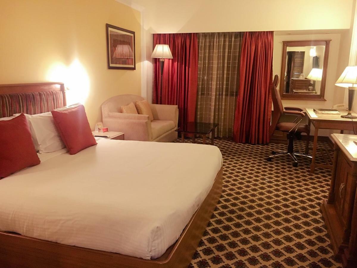 The Suryaa New Delhi Hotel Kültér fotó A room at the hotel
